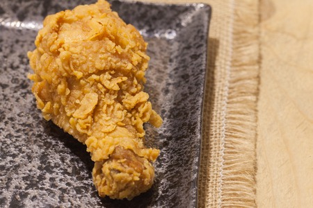 close up of fried chickens on black plateの写真素材