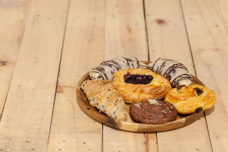 a variety of bakery on wooden plateの写真素材