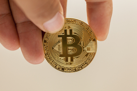 close up of hand holding metal bitcoinの写真素材