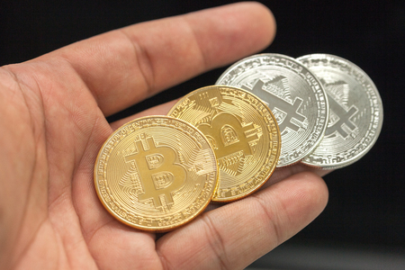 close up of hand holding metal bitcoinの写真素材
