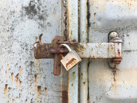 Old key lock on rusty freight container lockedのeditorial素材