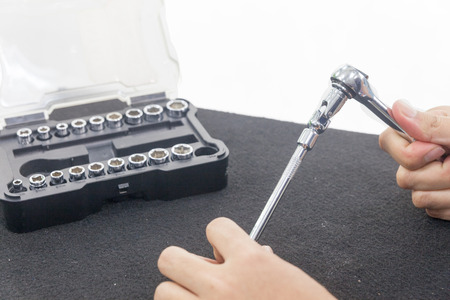 close up of Hand with Ratchet spanner on white backgroundの写真素材