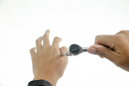close up of Hand with Ratchet spanner on white backgroundの写真素材