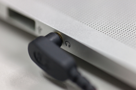 Plug in the headphones on the laptopの写真素材