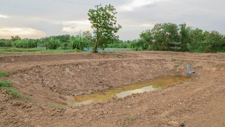 pond under construction with dried soil for farm