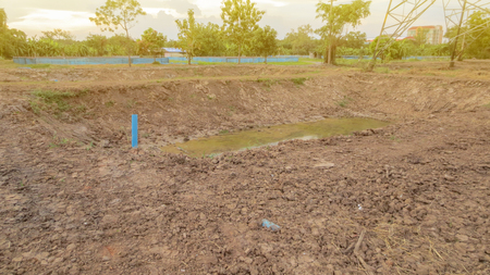 pond under construction with dried soil for farmの写真素材