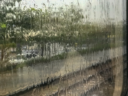 Rain Drop on glass windows with fast moving trainの写真素材
