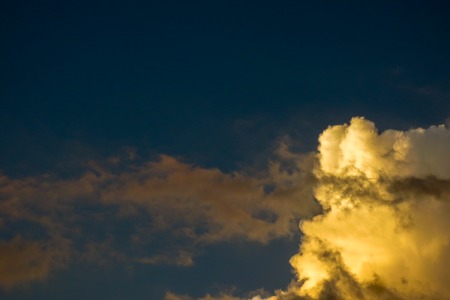 Golden clouds in the evening day with sunsets on the orange skyの写真素材