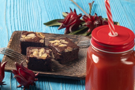 close up of Roselle juice and brownie cake on wooden blue backgroundの写真素材