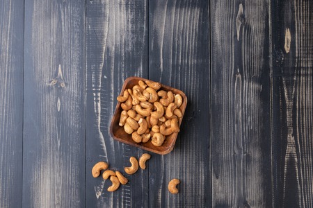 close up of Cashew nut on wooden bowlの写真素材