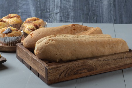 close up of bakery and bread on wooden board