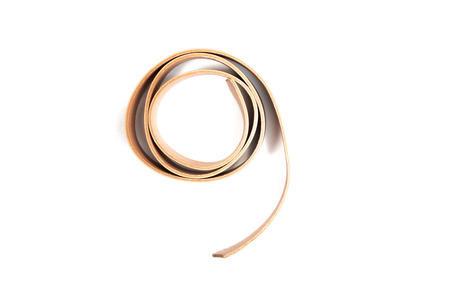 Working process of the leather belt on white backgroundの写真素材