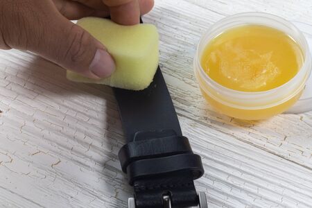 black leather belt and mink oil for care leather product