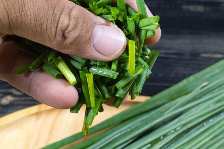 chopped of fresh scallion or spring onions on wooden boardの写真素材