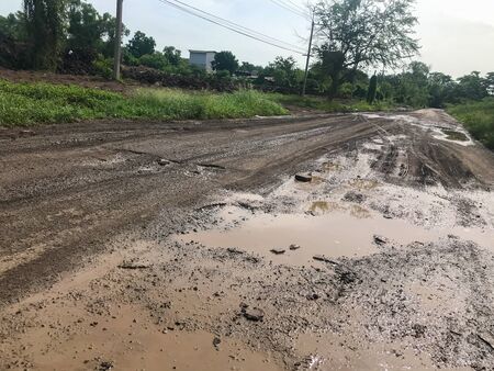 tire track dirty dirt road after raining at Thailandの写真素材