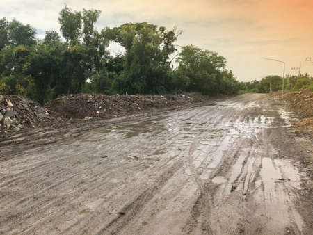 pile of dirt on dirty concrete road at thailand