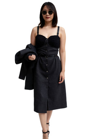 A woman in a black lace dress and sunglasses holds a jacket, standing against a white background.の素材