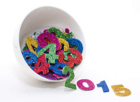 Number upcoming year, composed of set of shiny colored figures.