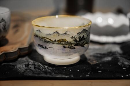 White porcelain cup with a landscape. White cup for traditional tea ceremony.の写真素材