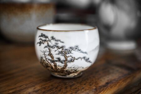 White ceramic cup with pine pattern. Jingdezhen porcelain cup for tea ceremony.の写真素材