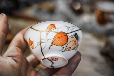 Kintsugi technique. Porcelain cup repaired with gold.の写真素材
