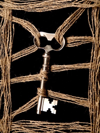 tied key  on dark backgroundの写真素材