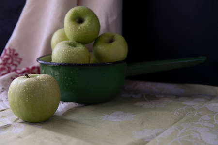 Fresh green apples in a green vintage bowlの写真素材
