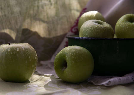 Fresh green apples in a green vintage bowlの写真素材