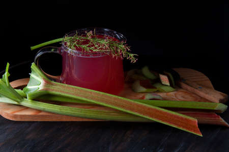 Rhubarb compote in glass vessel with cut stemsの写真素材