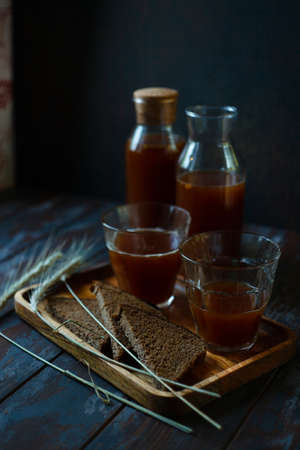 Two bottles and two glasses with traditional homemade beverage kvass in glass and bottles is a good summer cooling drink.の写真素材