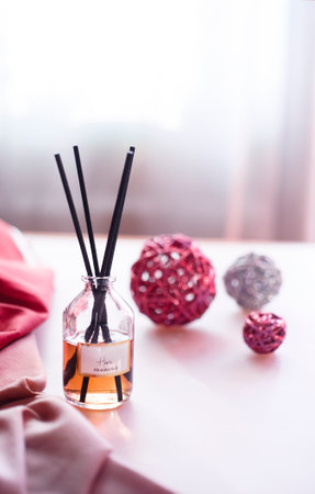 Aroma reed diffuser on white table with decorative interior balls.の写真素材