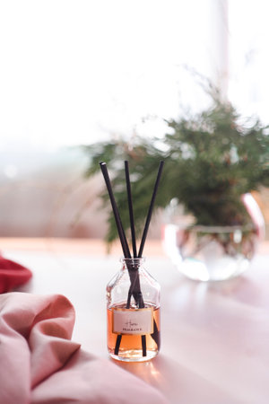 Aroma reed diffuser on white table in home interior.の写真素材