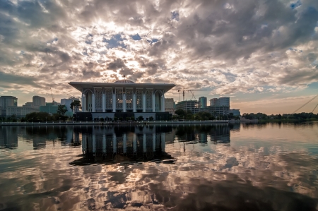 Beautiful mosque with reflection in Putrajaya, Malaysia by the lakeside during sunriseの写真素材