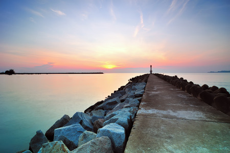 Pathway heading to a lighthouse at sunriseの写真素材