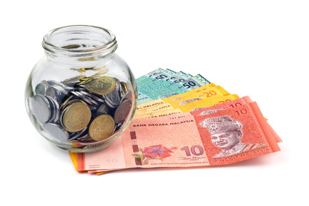 Saving concept. Banknotes and coins with a glass container isolated on white background.の写真素材