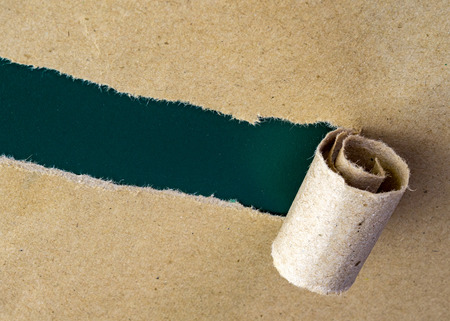 Torn brown paper on blank green rough surface.の写真素材