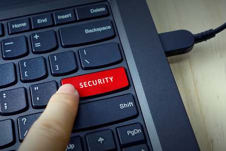 Close up of finger on keyboard button with SECURITY word