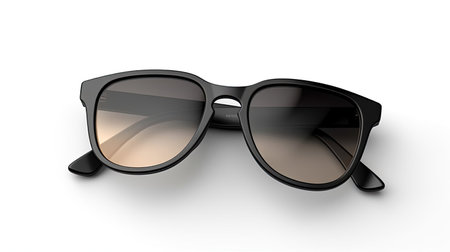 A sleek mockup of a pair of sunglasses with customizable frames isolated on white background top view.の素材