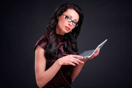 Business woman with a computer in handsの写真素材
