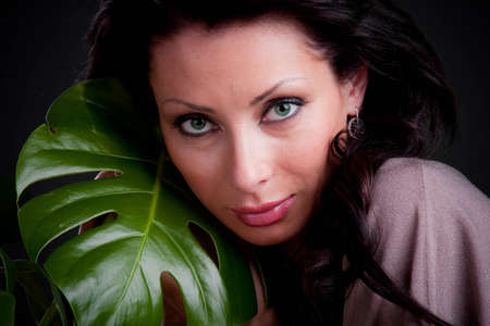 Sexy girl with a big green leaf