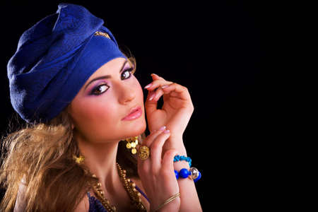 Beautiful girl in a turban and a stylized ethnic costumeの写真素材