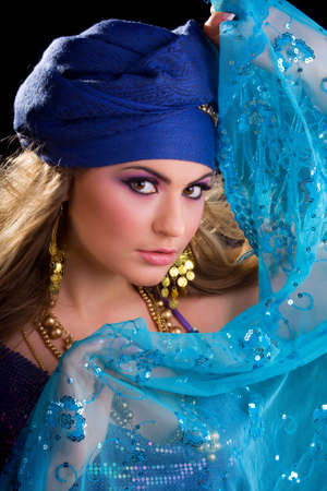 Beautiful girl in a turban girl holding a shawlの写真素材