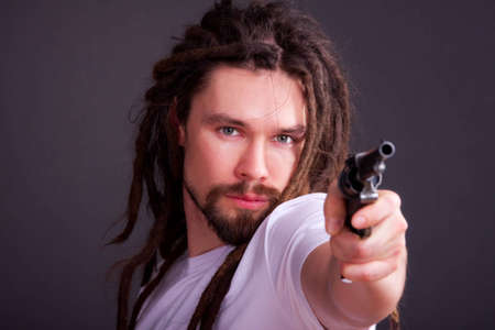 Guy posing with a gun in his handの写真素材
