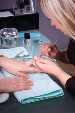 Manicure process with professional tools on female handの写真素材