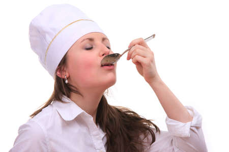 Beautiful young woman cooking isolated white backgroundの写真素材