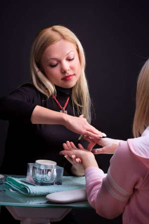 Manicure process. Pro at work with her client.の写真素材