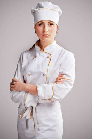 Young woman in white chef dress with hatの写真素材