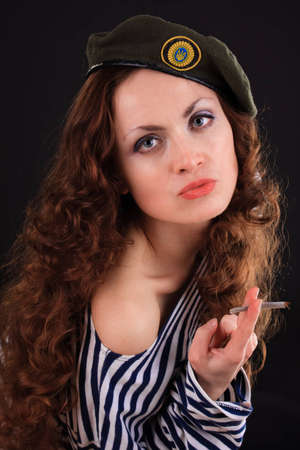 Emotional portrait of a girl in a vest and a military beretの写真素材