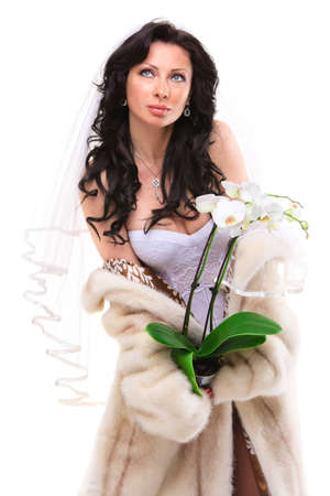 Studio portrait of a sexy brunette bride isolated on white backgroundの写真素材