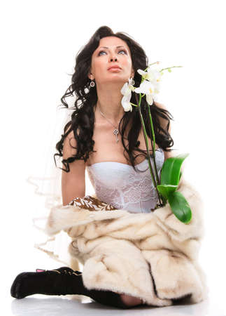 Studio portrait of a sexy brunette bride isolated on white backgroundの写真素材